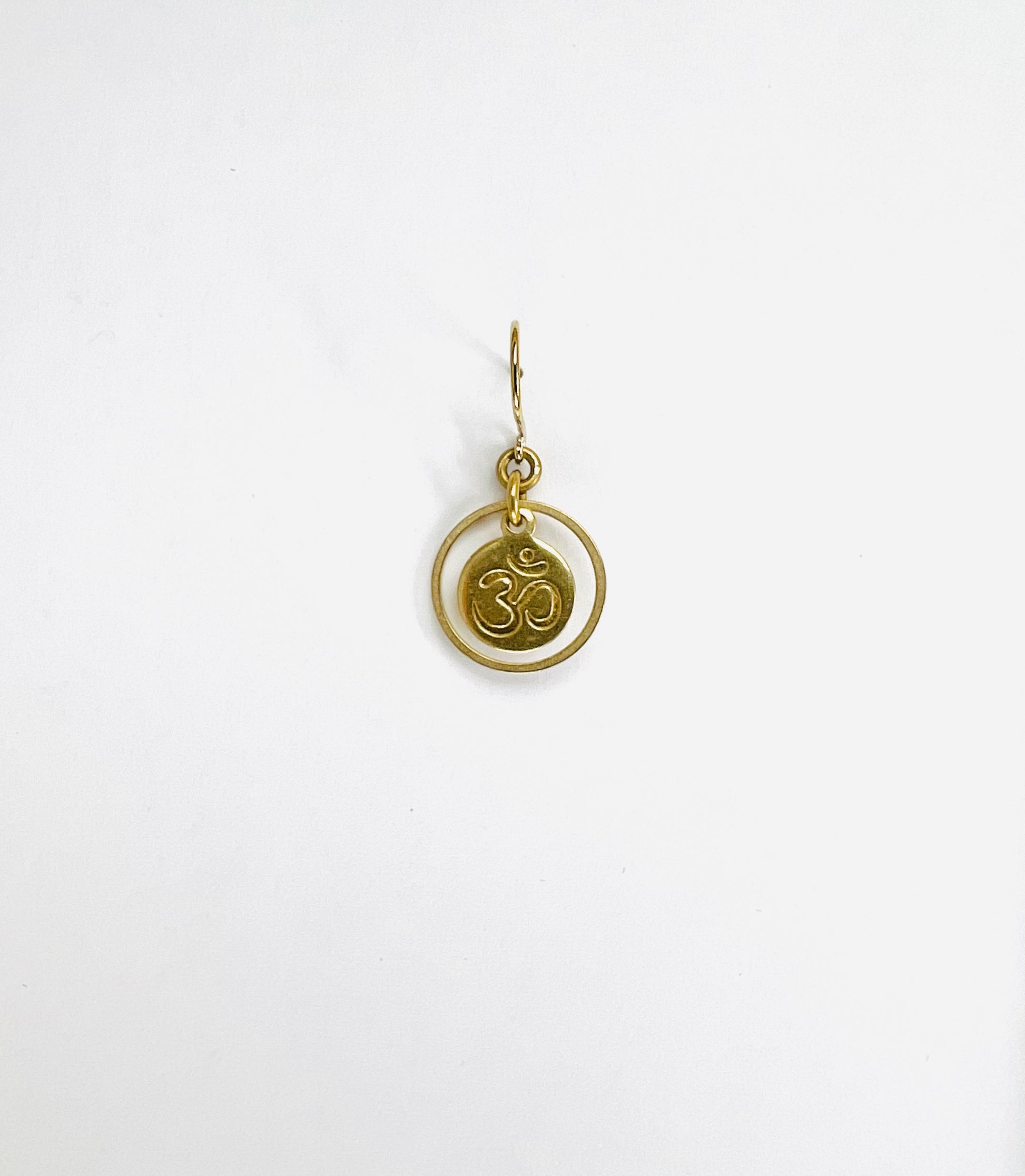 Brass ring and steel Om symbol single short earring, handcrafted minimalist intentional jewelry.