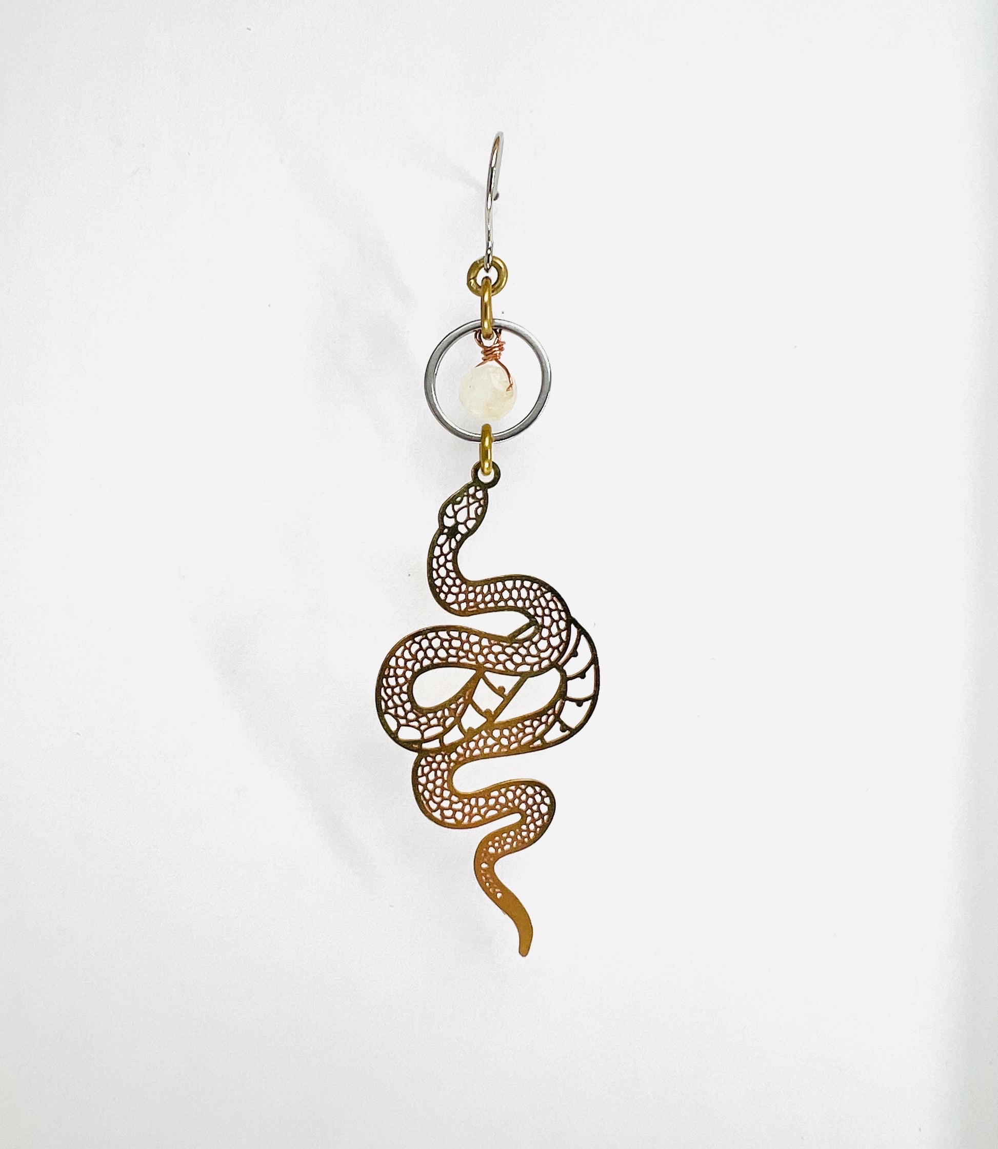gold and silver Snake-shaped earring on a white background
