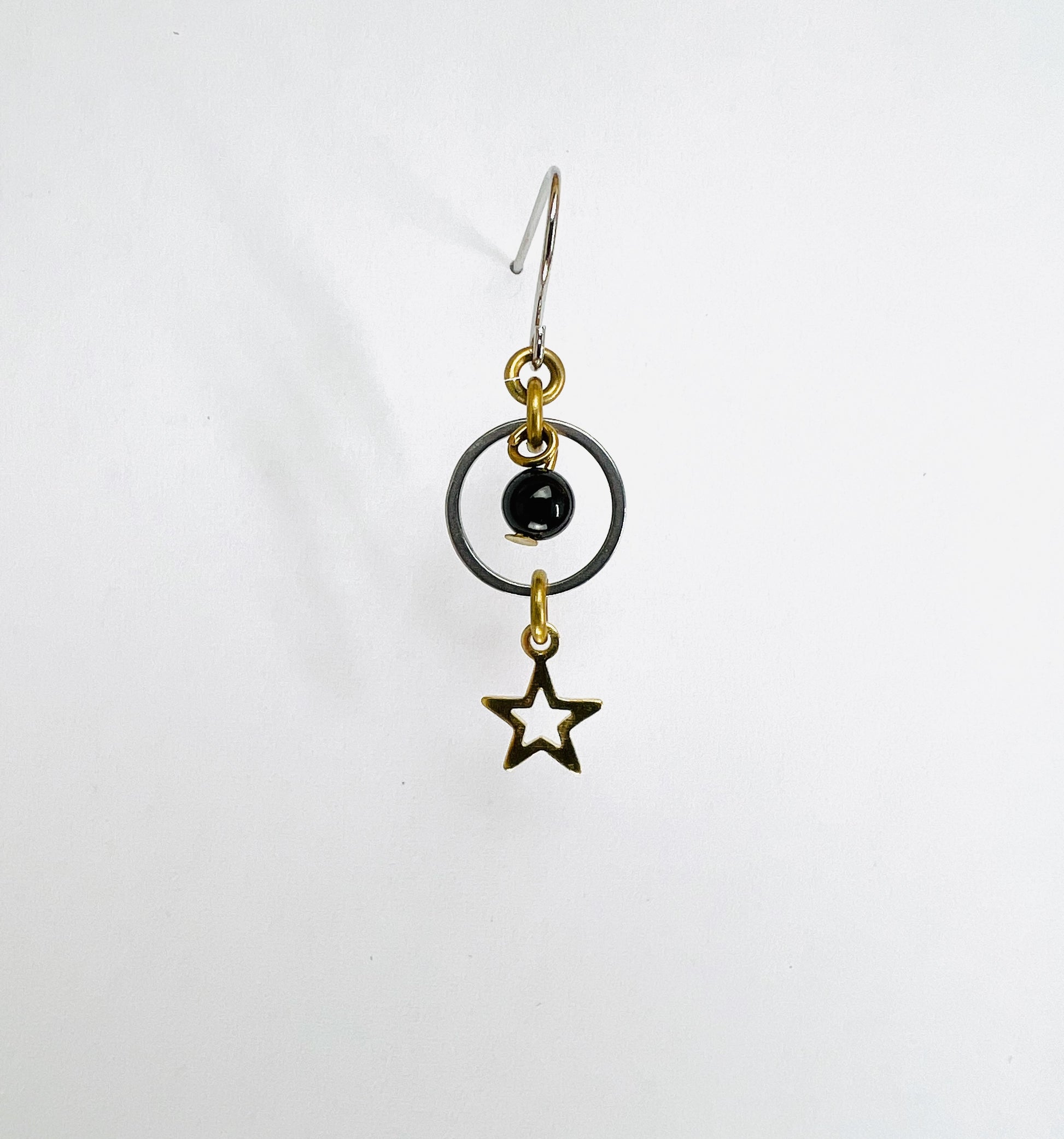 Onyx and star single crystal earring, handmade manifestation jewelry designed to support grounding, resilience, and personal strength.
