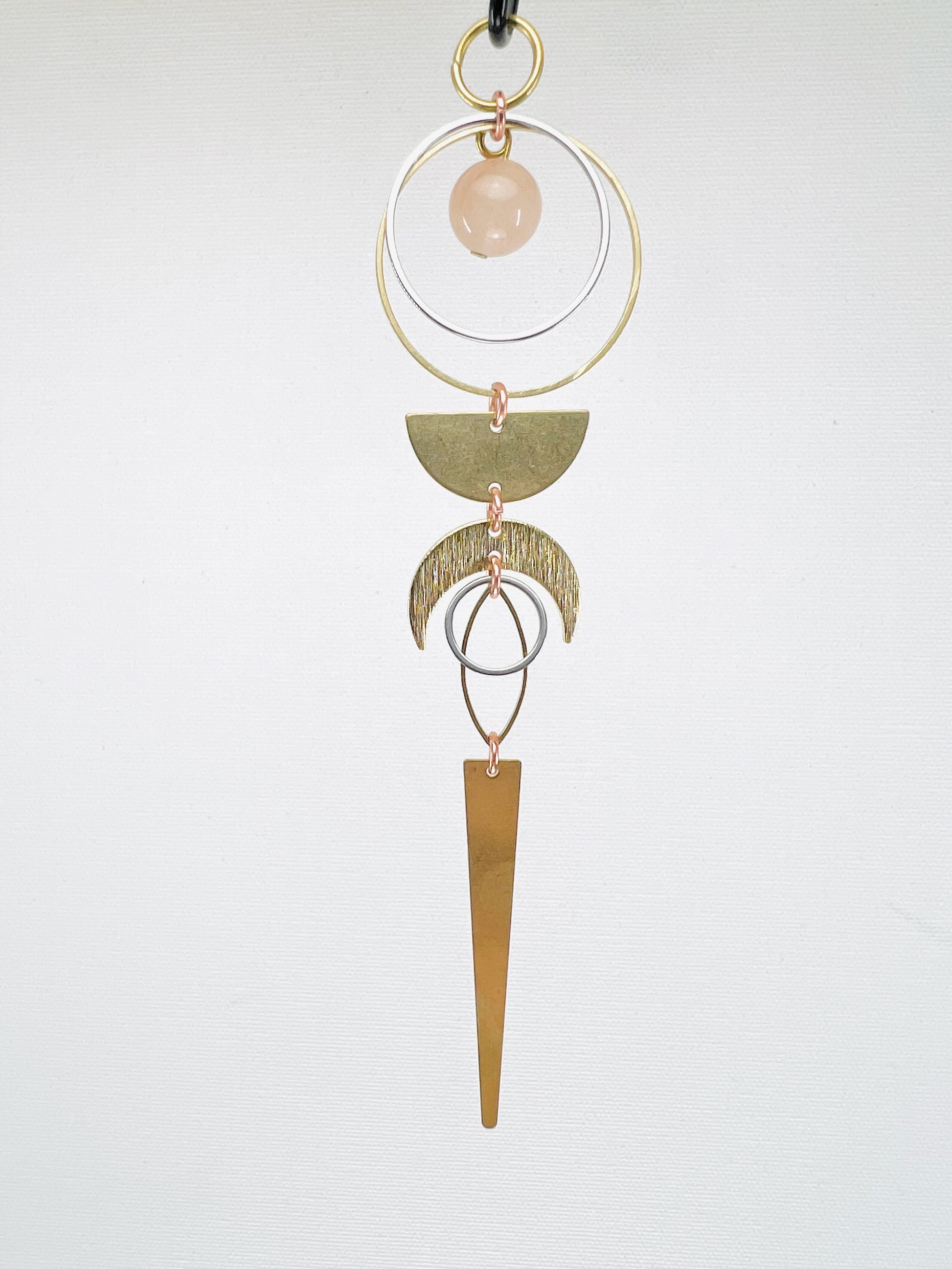 silver, stainless steel rings and gold, brass shapes of crescent moon, half circle, eye and long triangle. Peach Chalcedony manifestation mini, handcrafted intentional décor designed to support vitality, love, and gentle emotional strength.