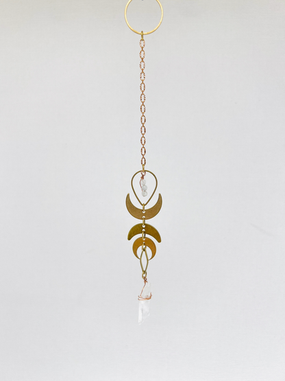 Handmade hanging art made of Moonstone, Clear Quartz, metal crescent moons and chain; a spiritual tool or pendulum, designed to support intuition, clarity, energetic alignment, and intentional choice making practices.