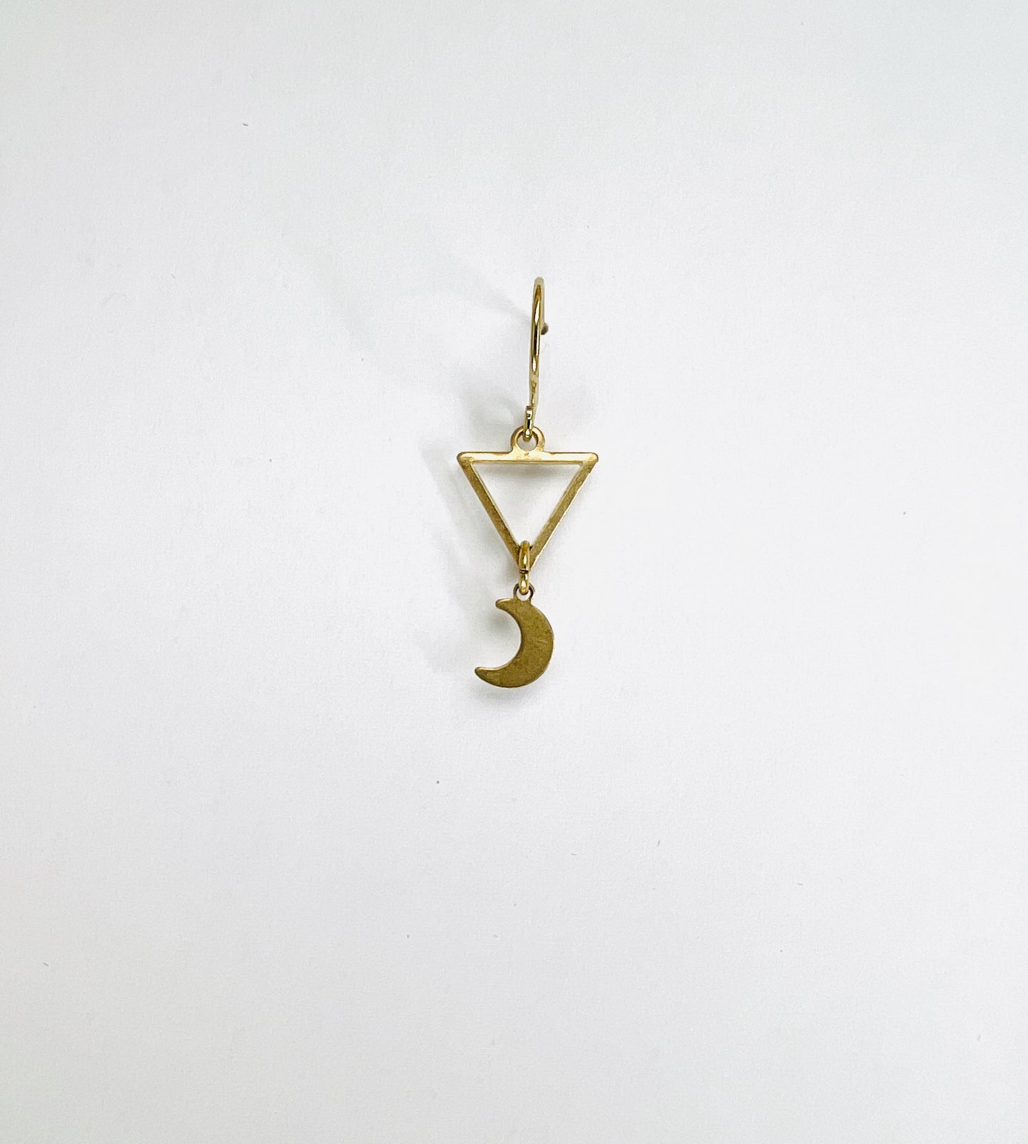 single Brass triangle and crescent moon earring, handcrafted minimalist intentional jewelry.