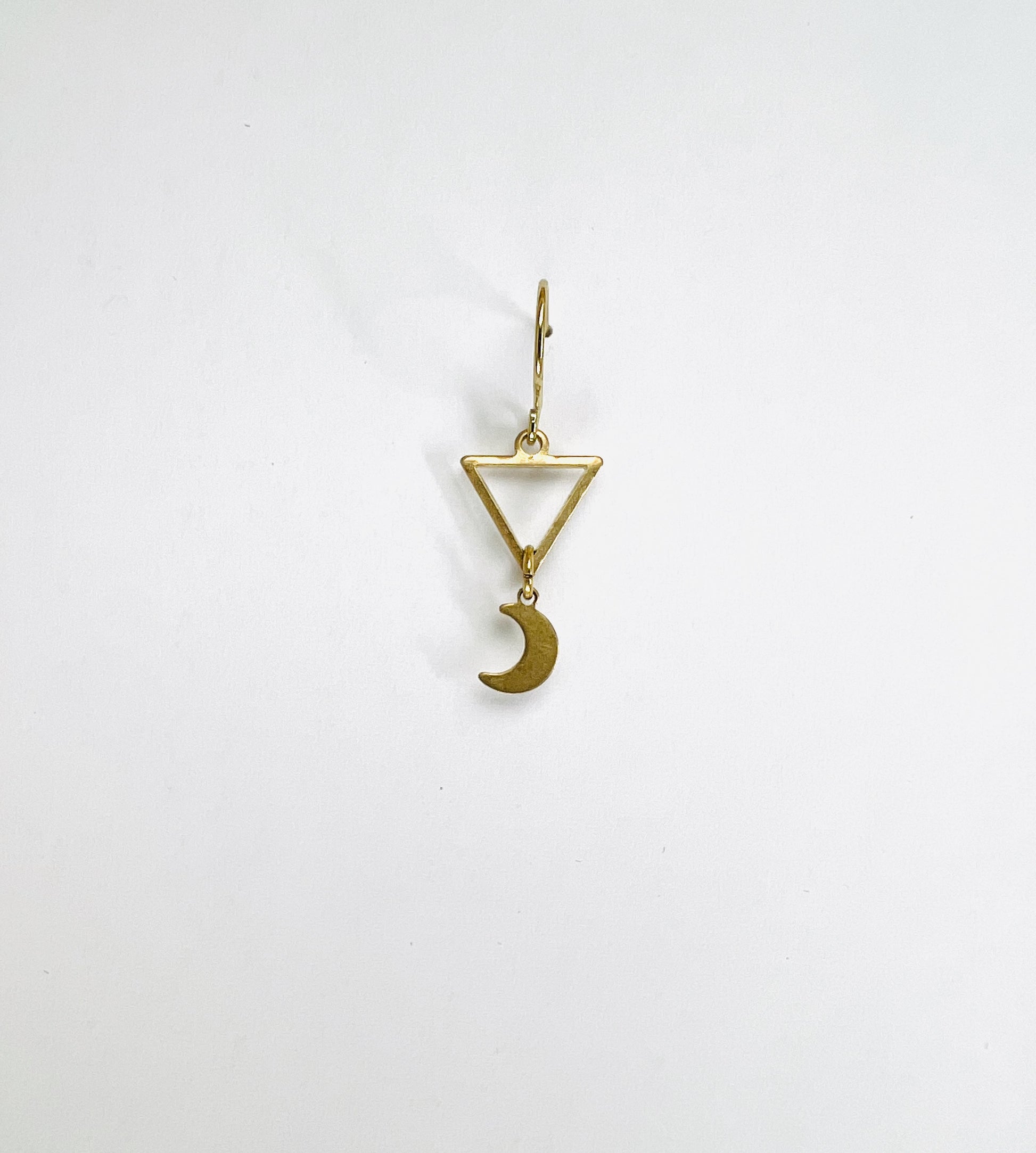 single Brass triangle and crescent moon earring, handcrafted minimalist intentional jewelry.