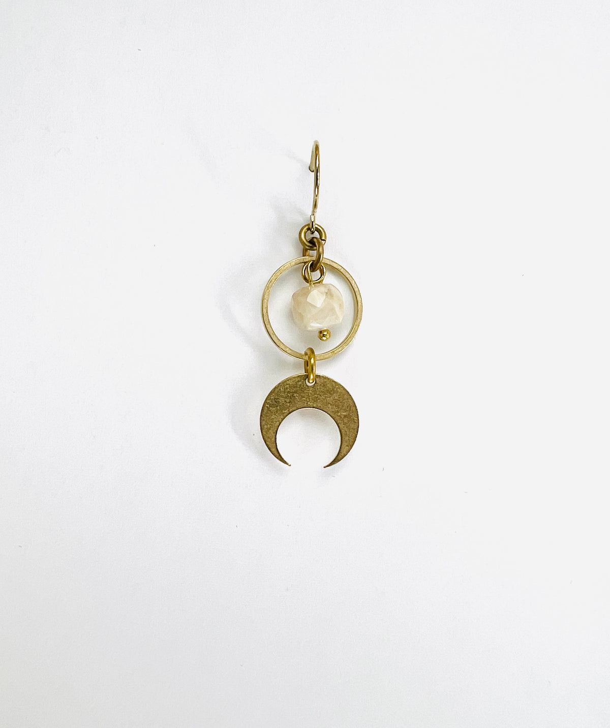 A single light gold crystal earring featuring a cream sunstone and a crescent moon charm, displayed against a white background.