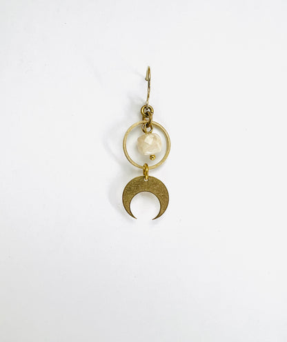 A single light gold crystal earring featuring a cream sunstone and a crescent moon charm, displayed against a white background.